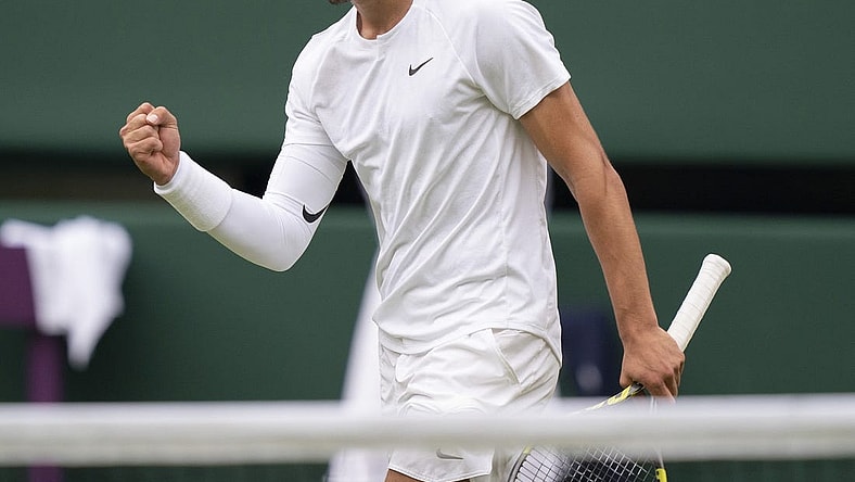 Jul 3, 2022; London, United Kingdom; Carlos Alcaraz (ESP) reacts to a point during his match against Jannik Sinner (ITA) on day seven at All England Lawn Tennis and Croquet Club. Mandatory Credit: Susan Mullane-USA TODAY Sports