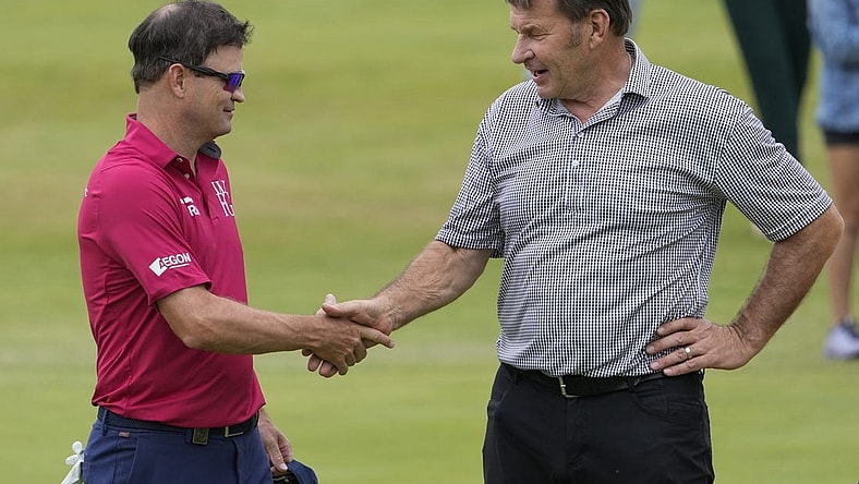 (File Photo) Zach Johnson (Left) and Nick Faldo shake hands on the 18th green during the Celebration of Champions at the 150th Open Championship golf tournament at St. Andrews Old Course. Mandatory Credit: Michael Madrid-USA TODAY Sports