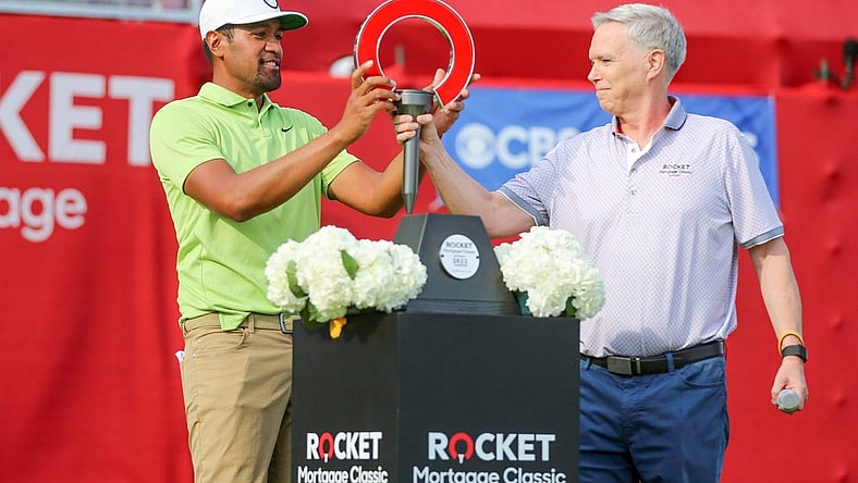 Tony Finau receives the 2022 Rocket Mortgage Classic trophy in joy after winning at the Detroit Golf Club last year. 

Rocket Mortgage Classic