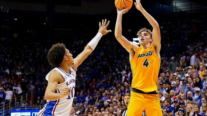 Nov 10, 2022; Lawrence, Kansas, USA; North Dakota State Bison forward Grant Nelson (4) shoots against Kansas Jayhawks forward Jalen Wilson (10) during the first half at Allen Fieldhouse. Mandatory Credit: Jay Biggerstaff-USA TODAY Sports