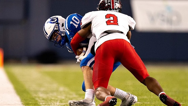 Cleveland Glenville defensive back Bryce West (2) tackles Wyoming Cowboys wide receiver Will Svendsen (10) causing a turnover on downs in the third quarter of the OHSAA DIV state championship game between at Tom Benson Hall of Fame Stadium in Canton, Ohio, on Saturday, Dec. 3, 2022.

High School Football Wyoming Vs Cleveland Glenville In Ohsaa Div State Championship Game