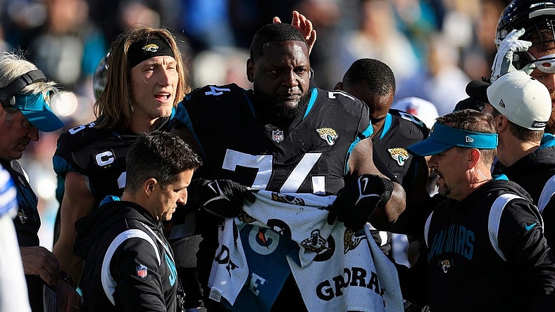 Jacksonville Jaguars offensive lineman Cam Robinson (74) tears up after an apparent injury as quarterback Trevor Lawrence (16) pats him on the head during the fourth quarter of a regular season NFL football matchup Sunday, Dec. 18, 2022 at TIAA Bank Field in Jacksonville. The Jacksonville Jaguars edged the Dallas Cowboys 40-34 in overtime.

Pom Dec 09