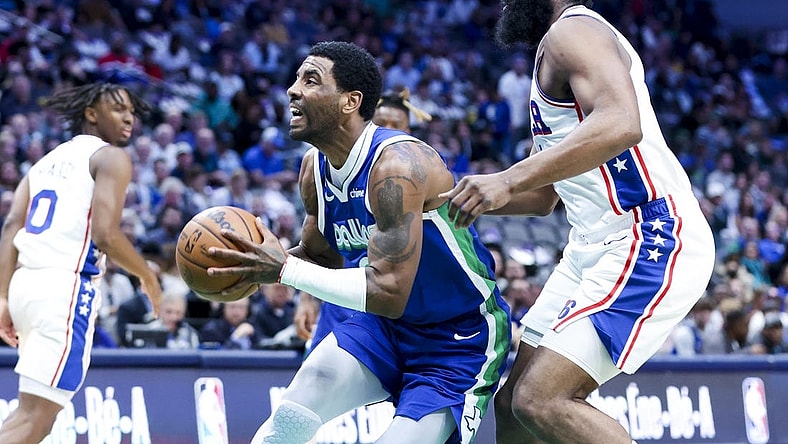 Mar 2, 2023; Dallas, Texas, USA; Dallas Mavericks guard Kyrie Irving (2) drives to the basket past Philadelphia 76ers guard James Harden (1) during the first quarter at American Airlines Center. Mandatory Credit: Kevin Jairaj-USA TODAY Sports
