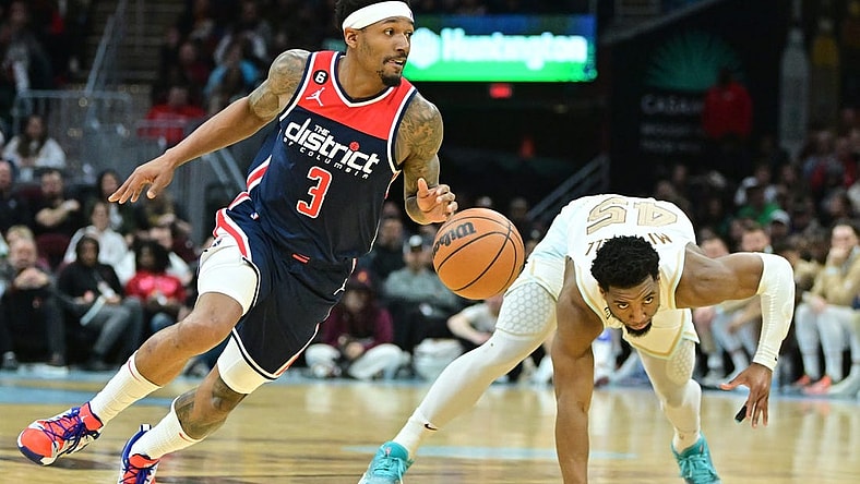 Mar 17, 2023; Cleveland, Ohio, USA; Washington Wizards guard Bradley Beal (3) and Cleveland Cavaliers guard Donovan Mitchell (45) go for a loose ball during the second half at Rocket Mortgage FieldHouse. Mandatory Credit: Ken Blaze-USA TODAY Sports