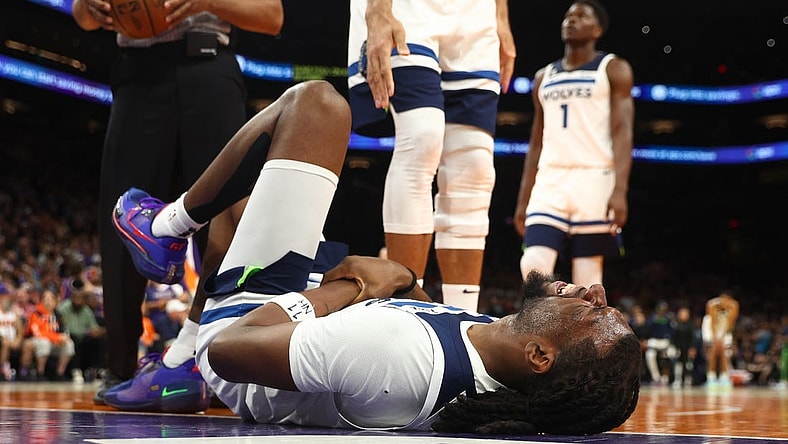 Mar 29, 2023; Phoenix, Arizona, USA; Minnesota Timberwolves center Naz Reid (11) reacts after suffering an injury against the Phoenix Suns in the second half at Footprint Center. Mandatory Credit: Mark J. Rebilas-USA TODAY Sports