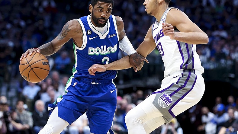 Apr 5, 2023; Dallas, Texas, USA;  Dallas Mavericks guard Kyrie Irving (2) drives to the basket as Sacramento Kings forward Keegan Murray (13) defends during the first half at American Airlines Center. Mandatory Credit: Kevin Jairaj-USA TODAY Sports