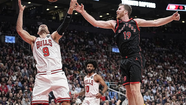 Apr 12, 2023; Toronto, Ontario, CAN; Chicago Bulls center Nikola Vucevic (9) and Toronto Raptors center Jakob Poeltl (19) battle for a rebound during the second half of a NBA Play-In game at Scotiabank Arena. Mandatory Credit: John E. Sokolowski-USA TODAY Sports