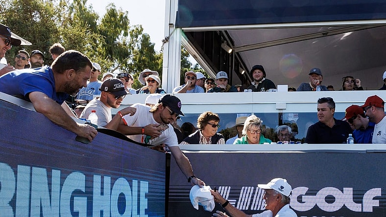 Apr 21, 2023; Adelaide, South Australia AUS;  Greg Norman signs autographs on the twelfth hole during the first round of LIV Golf Adelaide golf tournament at Grange Golf Club. Mandatory Credit: Mike Frey-USA TODAY Sports