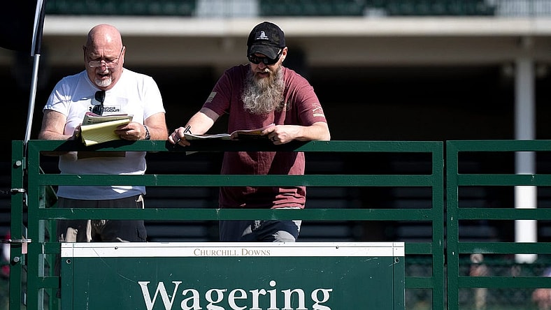 May 5, 2023; Louisville, KY, USA; Keith Shaffer and his son, Keith Shaffer Jr., prepare to make bets at Churchill Downs on Oaks Day, Friday, May 5, 2023, in Louisville, Ky. Mandatory Credit: Albert Cesare-USA TODAY Sports