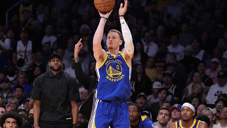 May 8, 2023; Los Angeles, California, USA; Golden State Warriors guard Donte DiVincenzo (0) shoots the ball against the Los Angeles Lakers in the second half of game four of the 2023 NBA playoffs at Crypto.com Arena. Mandatory Credit: Kirby Lee-USA TODAY Sports