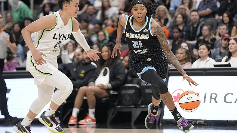 May 13, 2023; Toronto, Ontario, Canada; Chicago Sky forward Robyn Parks (21) dribbles around Minnesota Lynx guard Kayla McBride (21) during the first half at Scotiabank Arena. Mandatory Credit: John E. Sokolowski-USA TODAY Sports
