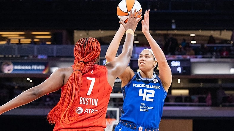 May 19, 2023; Indianapolis, Indiana, USA; Connecticut Sun center Brionna Jones (42) shoots the ball while Indiana Fever forward Aliyah Boston (7) defends in the first half at Gainbridge Fieldhouse. Mandatory Credit: Trevor Ruszkowski-USA TODAY Sports