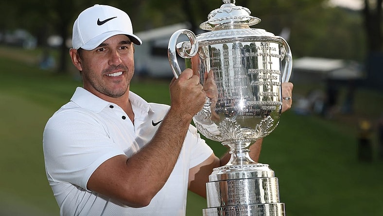 Brooks Koepka poses with the Wanamaker Trophy on the 18th green following his victory at the PGA Championship at Oak Hill Country Club Sunday, May 21, 2023.