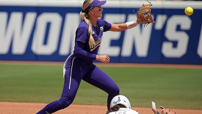Utah's Haley Denning (3) slides to second as Washington's Rylee Holtorf (3) waits on the ball in the second inning of a softball game between Utah and Washington in the Women's College World Series at USA Softball Hall of Fame Stadium in Oklahoma City, Friday, June 2, 2023. Washington won 4-1.