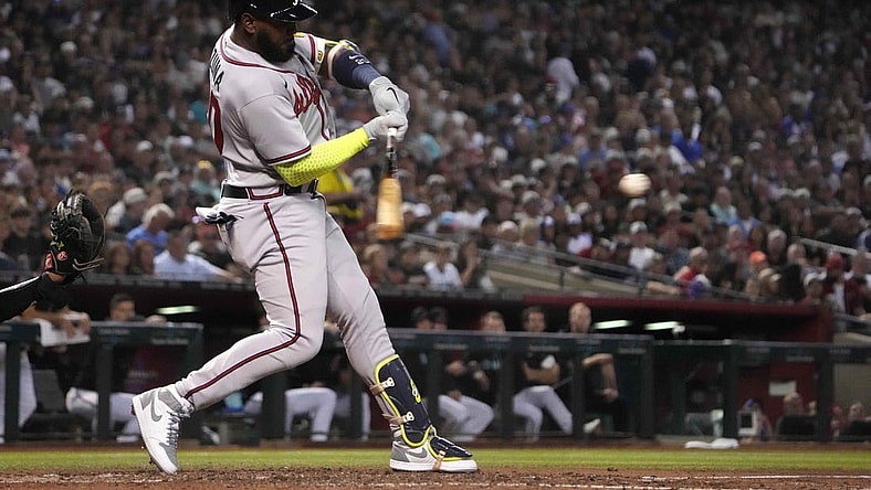 Jun 3, 2023; Phoenix, Arizona, USA; Atlanta Braves designated hitter Marcell Ozuna (20) hits an RBI single against the Arizona Diamondbacks during the fourth inning at Chase Field. Mandatory Credit: Joe Camporeale-USA TODAY Sports
