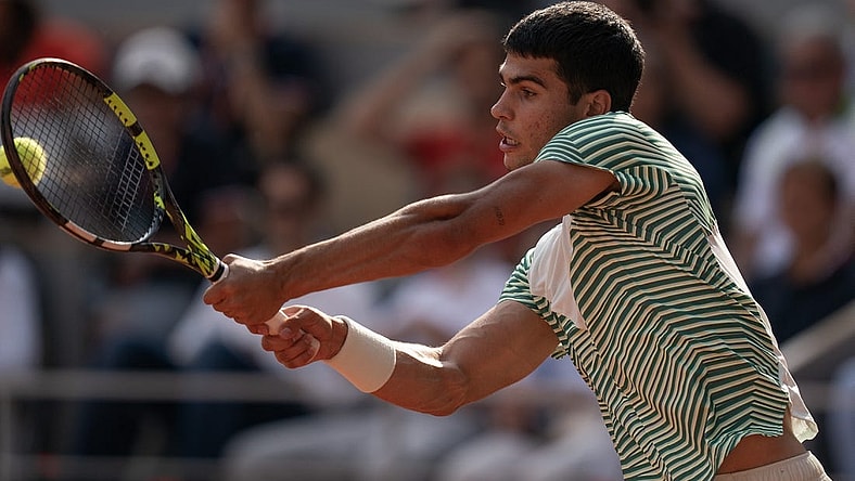 Jun 9 2023; Paris,France; Carlos Alcaraz (ESP) returns a shot during his semifinal match against Novak Djokovic (SRB) on day 13 at Stade Roland-Garros. Mandatory Credit: Susan Mullane-USA TODAY Sports