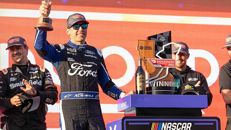 Jun 10, 2023; Sonoma, California, USA; NASCAR Xfinity Series driver Aric Almirola (128) celebrates after winning the NASCAR Xfinity Series DoorDash 250 at Sonoma Raceway. Mandatory Credit: Stan Szeto-USA TODAY Sports