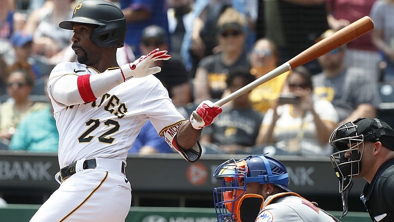 Jun 11, 2023; Pittsburgh, Pennsylvania, USA; Pittsburgh Pirates designated hitter Andrew McCutchen (22) hits a single to register his 2000th career major league hit during the first inning against the New York Mets at PNC Park. Mandatory Credit: Charles LeClaire-USA TODAY Sports