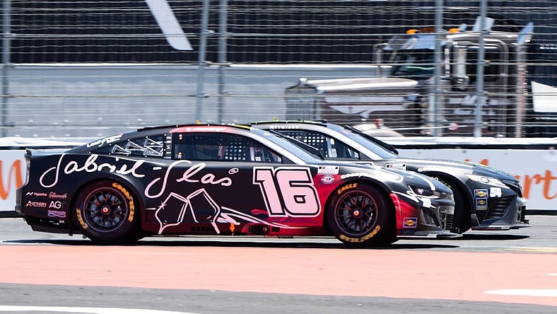 Jun 11, 2023; Sonoma, California, USA;  NASCAR Cup Series driver AJ Allmendinger (16) races against NASCAR Cup Series driver Ty Gibbs (54) at Sonoma Raceway. Mandatory Credit: Stan Szeto-USA TODAY Sports
