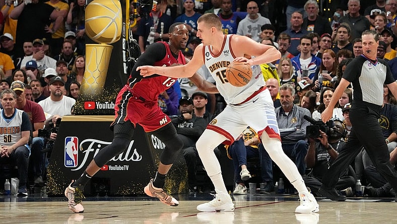 Jun 12, 2023; Denver, Colorado, USA; Denver Nuggets center Nikola Jokic (15) dribbles the ball against Miami Heat center Bam Adebayo (13) during the third quarter in game five of the 2023 NBA Finals at Ball Arena. Mandatory Credit: Kyle Terada-USA TODAY Sports