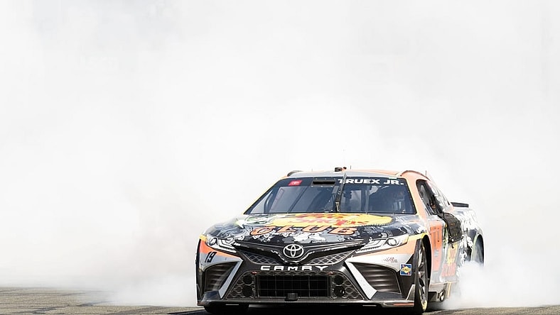 Jun 11, 2023; Sonoma, California, USA;  NASCAR Cup Series driver Martin Truex Jr. (19) celebrates after winning the Toyota / Save Mart 350 at Sonoma Raceway. Mandatory Credit: Stan Szeto-USA TODAY Sports