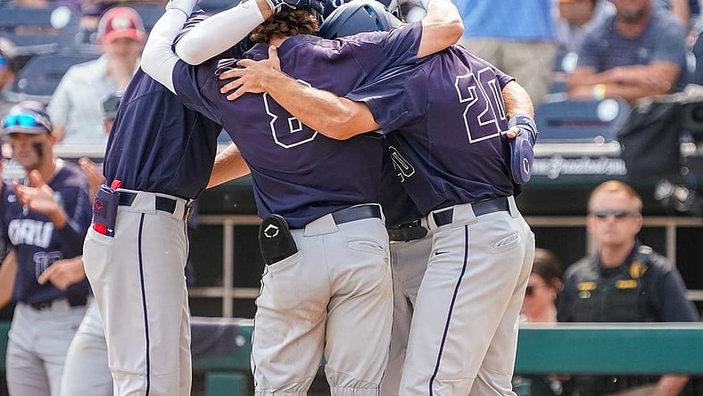 Jun 16, 2023; Omaha, NE, USA; Oral Roberts Golden Eagles second baseman Blaze Brothers (8), outfielder Sam Thompson (20), first baseman Jake McMurray (4) and third baseman Holden Breeze (5) celebrate after a three-run home run by Brothers during the ninth inning at Charles Schwab Field Omaha. Mandatory Credit: Dylan Widger-USA TODAY Sports