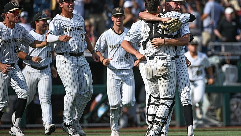 Jun 17, 2023; Omaha, NE, USA; Wake Forest Demon Deacons pitcher Camden Minacci (14) and catcher Bennett Lee (27) celebrate after defeating the Stanford Cardinal at Charles Schwab Field Omaha. Mandatory Credit: Steven Branscombe-USA TODAY Sports