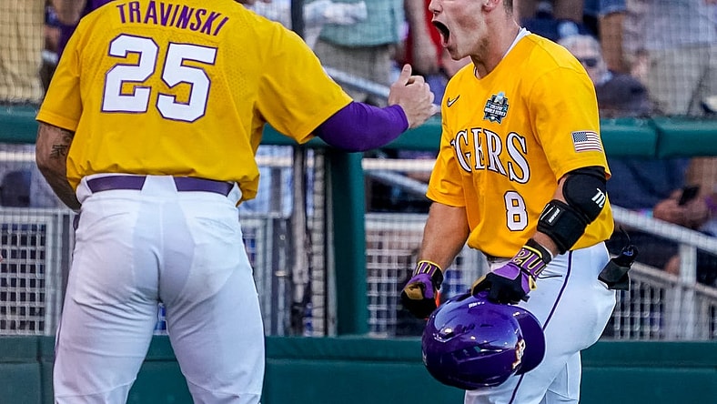 Jun 24, 2023; Omaha, NE, USA; LSU Tigers second baseman Gavin Dugas (8) celebrates with catcher Hayden Travinski (25) after scoring a home run against the Florida Gators during the third inning at Charles Schwab Field Omaha. Mandatory Credit: Dylan Widger-USA TODAY Sports