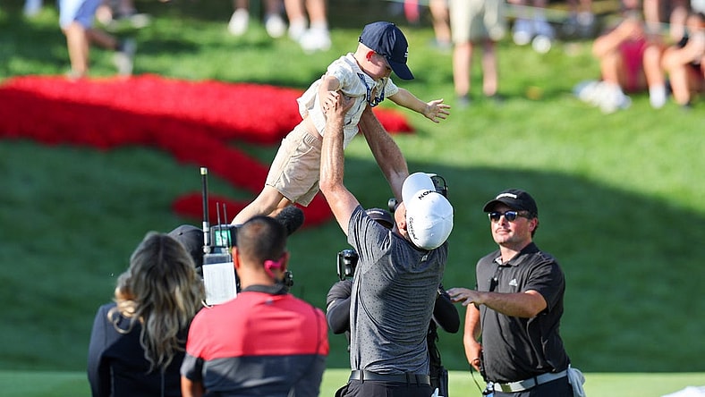 Jun 25, 2023; Cromwell, Connecticut, USA; Keegan Bradley celebrates with his son Logan James after winning the Travelers Championship golf tournament. Mandatory Credit: Vincent Carchietta-USA TODAY Sports