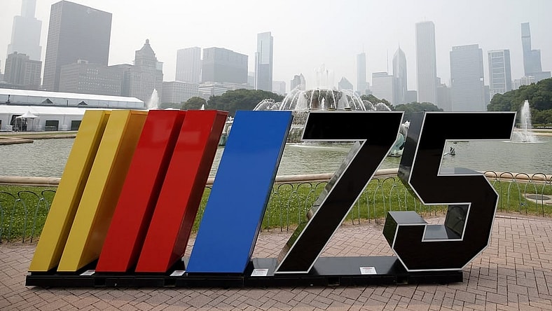 Jun 27, 2023; Chicago, Illinois, USA; A general view of a NASCAR sign next to Buckingham Fountain before the Chicago Street Race as smoke from Canadian wildfires obscures the skyline. Mandatory Credit: Jon Durr-USA TODAY Sports
