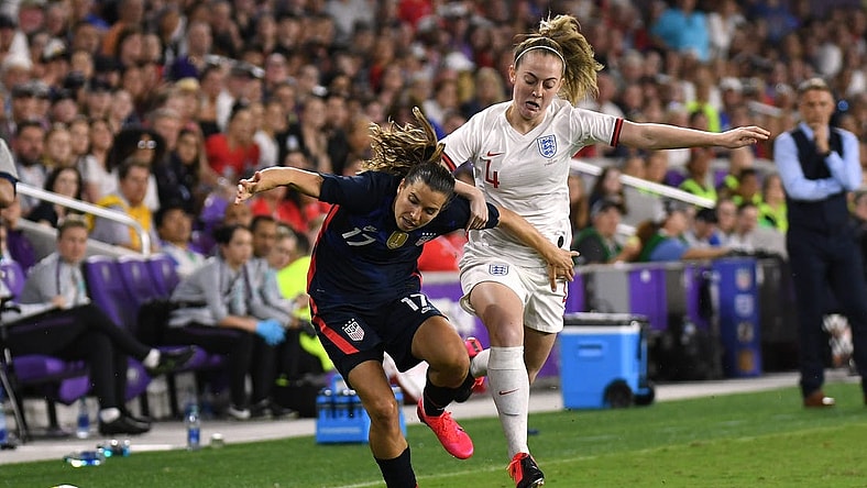Mar 5, 2020; Orlando, Florida, USA; Team USA forward Tobin Heath (17) and Team England midfielder Keira Walsh (4) chase down the loose ball in the first half during the She Believes Cup soccer series at Exploria Stadium. Mandatory Credit: Jonathan Dyer-USA TODAY Sports