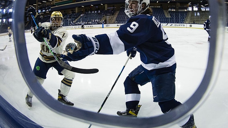 Mar 14, 2021; South Bend, Indiana, USA; Penn State's Alex Limoges (9) reaches out to grab a puck as Notre Dame s Jesse Lansdell (14) defends at the Compton Family Ice Arena. Mandatory Credit: Michael Caterina/South Bend Tribune-USA TODAY NETWORK