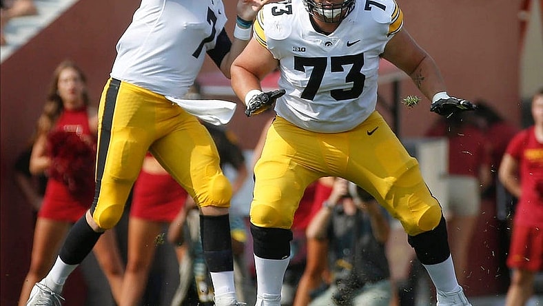 Iowa junior offensive lineman Cody Ince (No. 73) protects the line as junior quarterback Spencer Petras throws a pass in the first quarter against Iowa State at Jack Trice Stadium in Ames on Saturday, Sept. 11, 2021.

20210911 Cyhawk