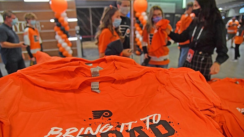 Oct 15, 2021; Philadelphia, Pennsylvania, USA; Philadelphia Flyers fans receive free t-shirt on opening night against the Vancouver Canucks at Wells Fargo Center. Mandatory Credit: Eric Hartline-USA TODAY Sports