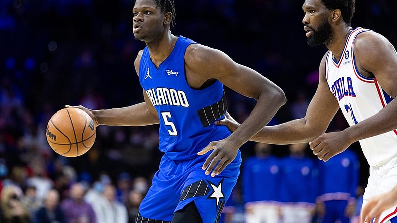 Jan 19, 2022; Philadelphia, Pennsylvania, USA; Orlando Magic center Mo Bamba (5) dribbles the ball against Philadelphia 76ers center Joel Embiid (21) during the third quarter at Wells Fargo Center. Mandatory Credit: Bill Streicher-USA TODAY Sports
