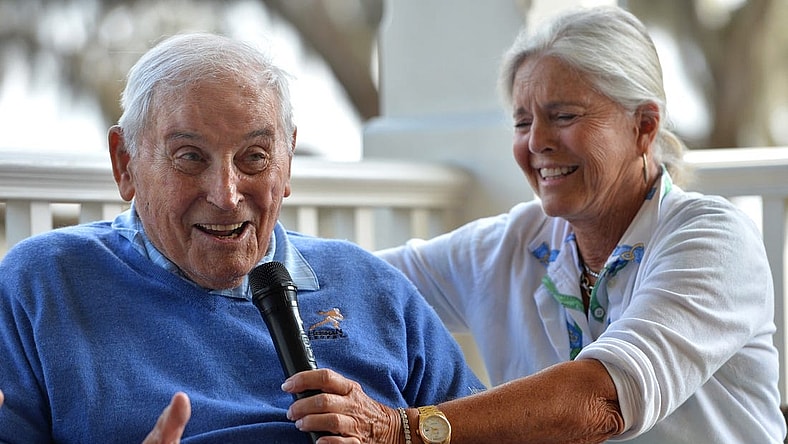 Mary Lujack, right, holds a microphone for her father, Johnny Lujack, winner of the 1947 Heisman Memorial Trophy at The Founder's Club on Tuesday. Lujack spoke to members on the veranda of the clubhouse after accompanying his daughter and some of her friends on the golf course.

Sar Lujack Heisman 001