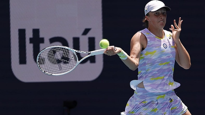 Apr 2, 2022; Miami Gardens, FL, USA;  Iga Swiatek (POL) hits a forehand against Naomi Osaka (JPN)(not pictured) in the women's singles final in the Miami Open at Hard Rock Stadium. Mandatory Credit: Geoff Burke-USA TODAY Sports