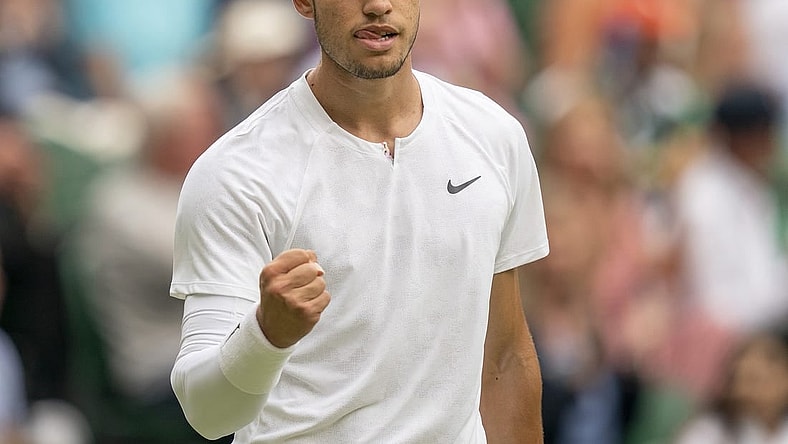Jul 3, 2022; London, United Kingdom; Carlos Alcaraz (ESP) reacts to a point during his match against Jannik Sinner (ITA) on day seven at All England Lawn Tennis and Croquet Club. Mandatory Credit: Susan Mullane-USA TODAY Sports