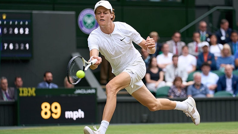 Jul 5, 2022; London, England, United Kingdom; Jannik Sinner (ITA) returns a shot against Novak Djokovic (SRB) during a quarterfinals mens singles match on Centre court at the 2022 Wimbledon Championships at All England Lawn Tennis and Croquet Club. Mandatory Credit: Peter van den Berg-USA TODAY Sports
