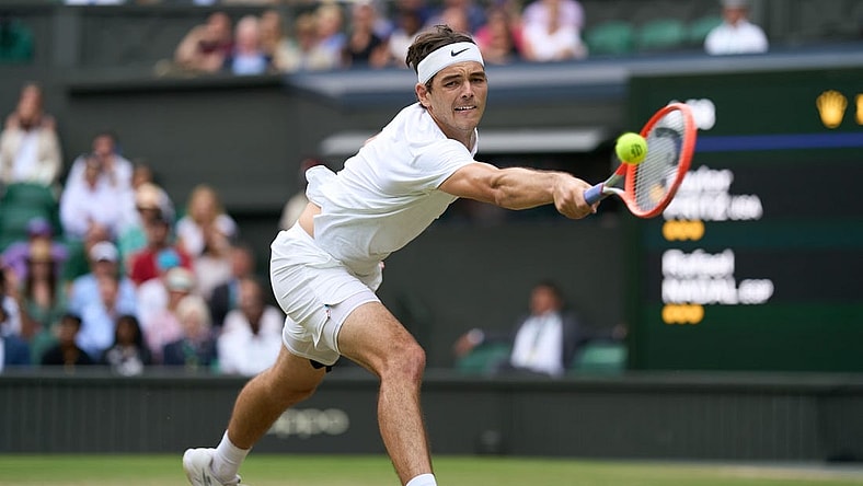 Jul 6, 2022; London, England, United Kingdom; Taylor Fritz (USA) returns a shot during his quarter finals men   s singles match against Rafael Nadal (ESP) on Centre court at All England Lawn Tennis and Croquet Club. Mandatory Credit: Peter van den Berg-USA TODAY Sports