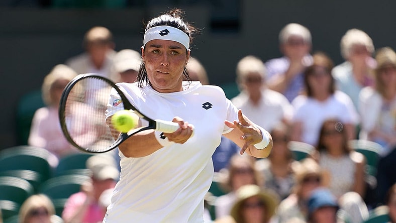 Jul 7, 2022; London, England, United Kingdom;  Ons Jabeur (TUN) returns a shot during  her semi finals women   s singles match against Tatjana Maria (GER) on Centre court at All England Lawn Tennis and Croquet Club. Mandatory Credit: Peter van den Berg-USA TODAY Sports