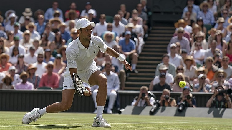 Jul 10, 2022; London, United Kingdom; Novak Djokovic (SRB) returns a shot during the men   s final against Nick Kyrgios (not pictured) on day 14 at All England Lawn Tennis and Croquet Club. Mandatory Credit: Susan Mullane-USA TODAY Sports