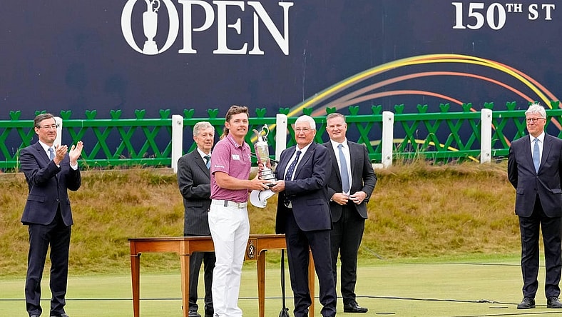 Jul 17, 2022; St. Andrews, SCT; Cameron Smith is presented the claret jug after winning the 150th Open Championship golf tournament at St. Andrews Old Course. Mandatory Credit: Michael Madrid-USA TODAY Sports