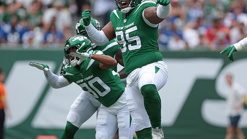 Aug 28, 2022; East Rutherford, New Jersey, USA; New York Jets defensive tackle Quinnen Williams (95) celebrates his sack with cornerback Michael Carter II (30) during the first half against the New York Giants at MetLife Stadium. Mandatory Credit: Vincent Carchietta-USA TODAY Sports