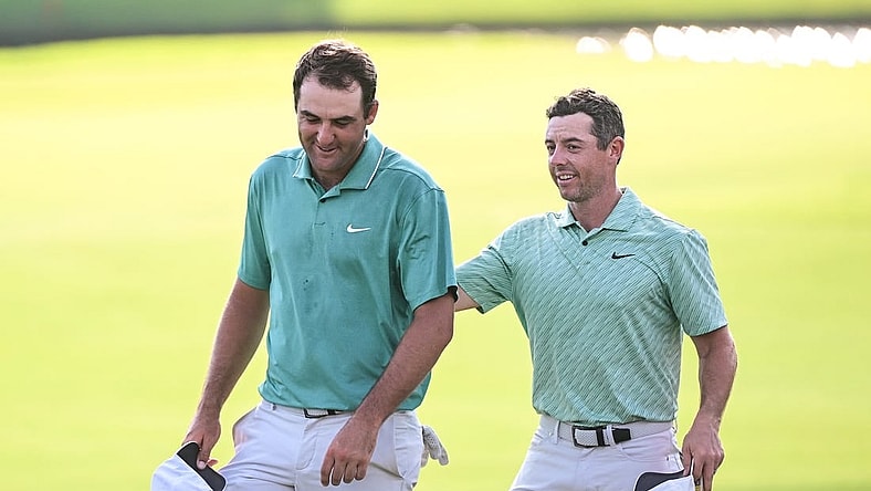 Aug 28, 2022; Atlanta, Georgia, USA; Scottie Scheffler and Rory McIlroy walk of the 18th green during the final round of the TOUR Championship golf tournament. Mandatory Credit: Adam Hagy-USA TODAY Sports