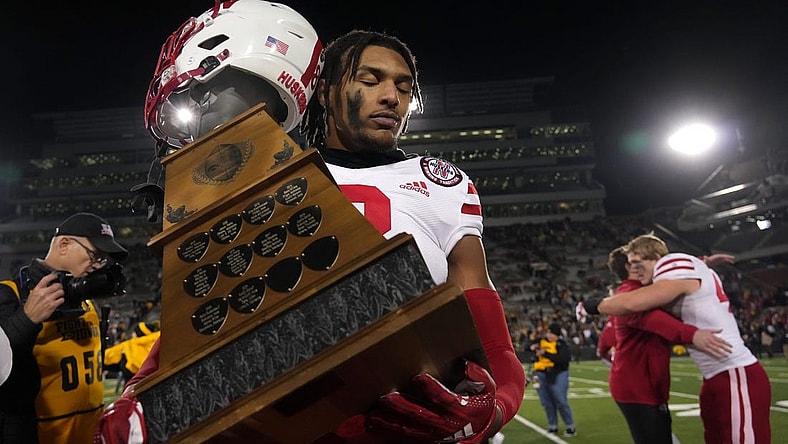 Nebraska safety Myles Farmer carries the Heroes Trophy off the field after the Cornhuskers beat Iowa, 24-17, on Friday, Nov. 25, 2022, at Kinnick Stadium in Iowa City.

Iowavsneb 20221125 Bh