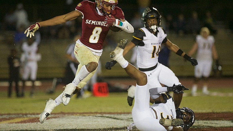 Florida High junior Micahi Danzy (8) leaps through the air in the Class 2S state semifinal matchup between Florida High and Bishop Verot on Dec. 2, 2022, at Mike Hickman Stadium. The Seminoles won, 38-28.

J9t8323
