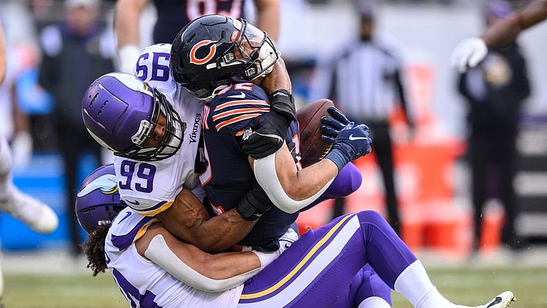 Jan 8, 2023; Chicago, Illinois, USA; Chicago Bears running back David Montgomery (32) runs the ball and is tackled by Minnesota Vikings inside linebacker Eric Kendricks (54) and outside linebacker Danielle Hunter (99) during the first quarter at Soldier Field. Mandatory Credit: Daniel Bartel-USA TODAY Sports