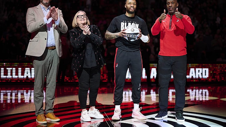 Portland Trail Blazers GM Joe Cronin, left, owner Jody Allen, and head coach Chauncey Billups stand with guard Damian Lillard (0) as he is congratulated on making the NBA All Star team before a game against the Washington Wizards at Moda Center. Mandatory Credit: Troy Wayrynen-USA TODAY Sports