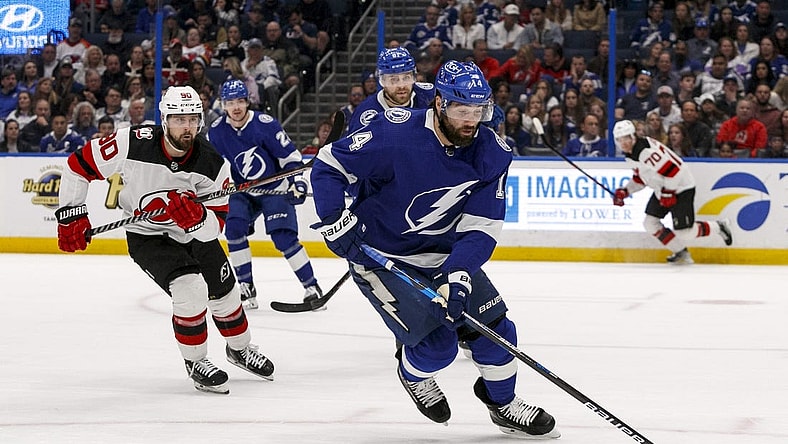 Mar 19, 2023; Tampa, Florida, USA; Tampa Bay Lightning left wing Pat Maroon (14) carries puck past New Jersey Devils left wing Tomas Tatar (90) during the second period at Amalie Arena. Mandatory Credit: Morgan Tencza-USA TODAY Sports